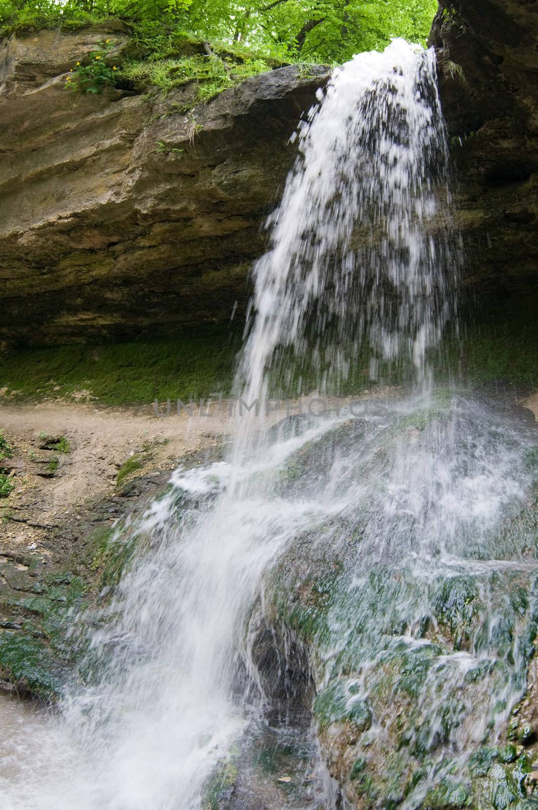 small rocky waterfall in the forest, motion blur