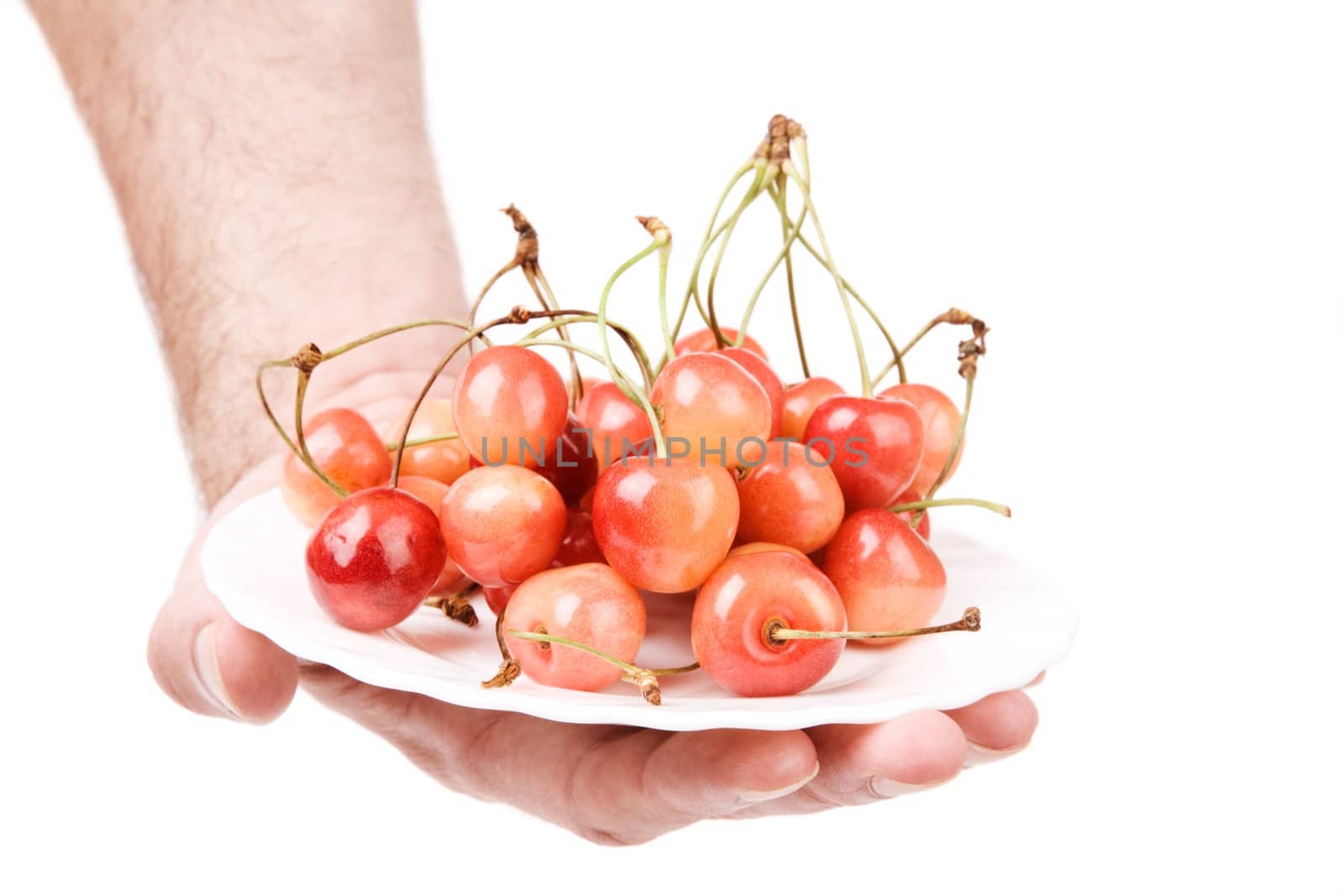 hand with cherry isolated on white background, focus on center