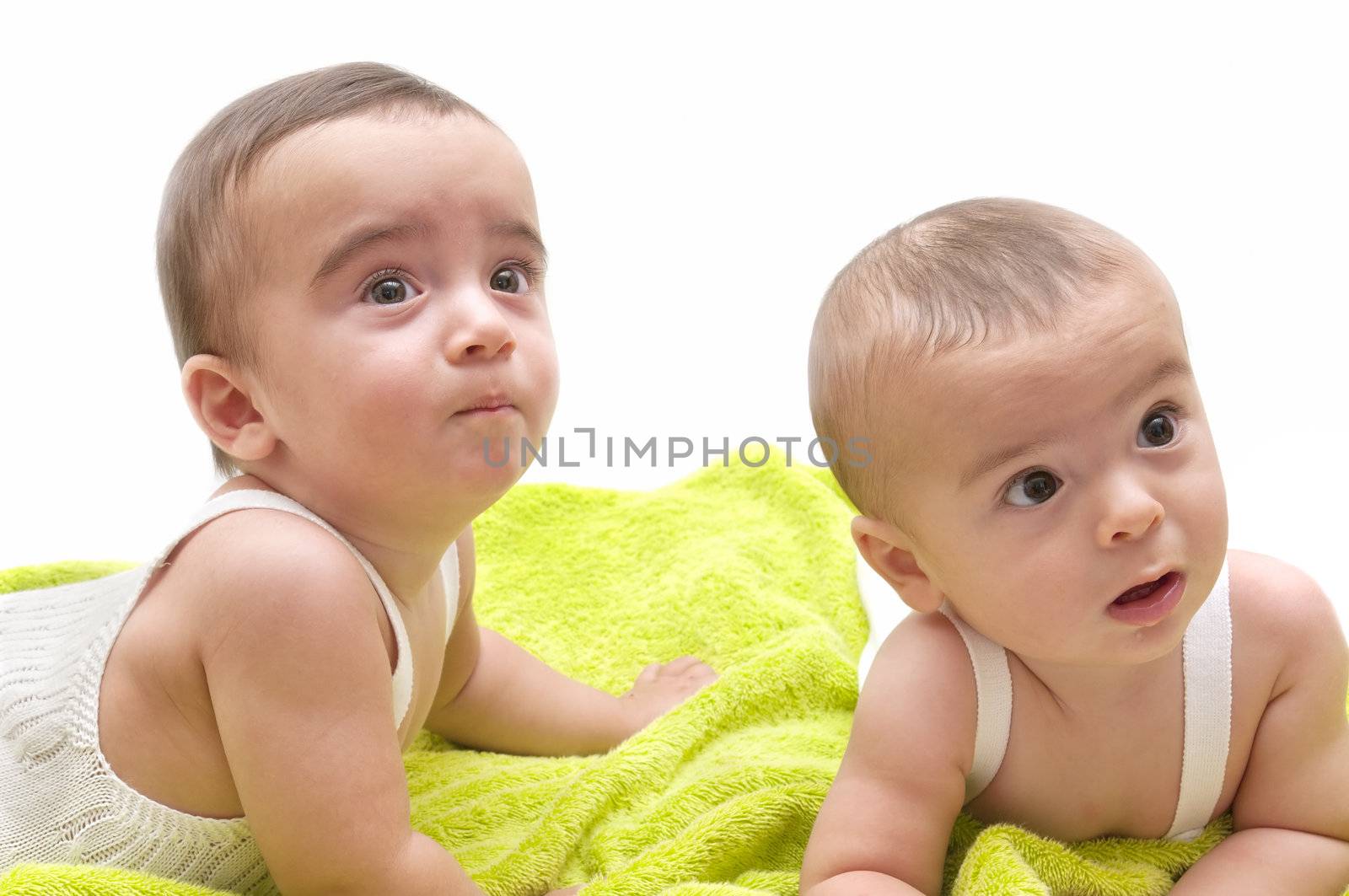 beautiful babies with the green towel on white background
