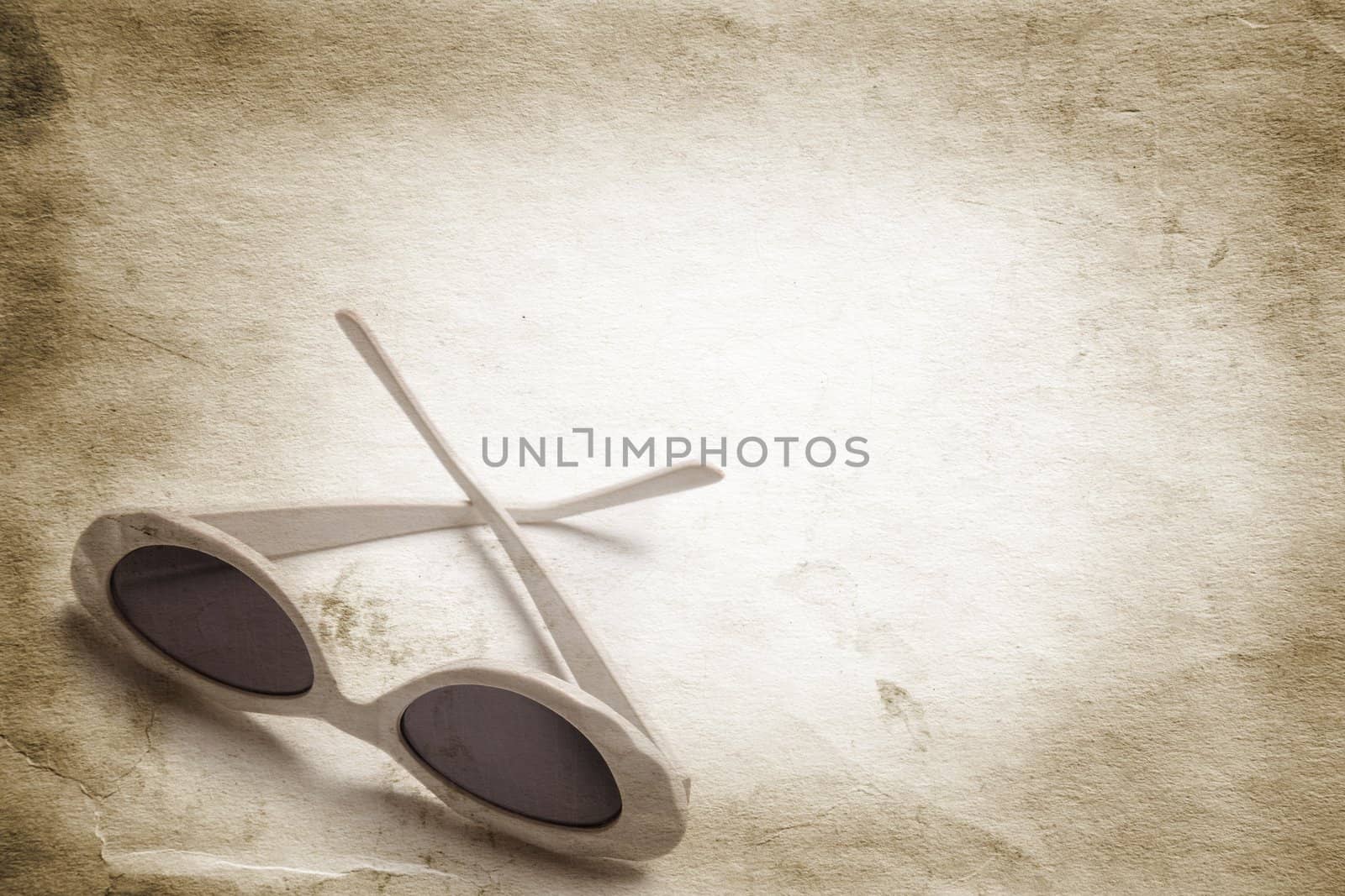 female eye-wear on grunge toned paper textured