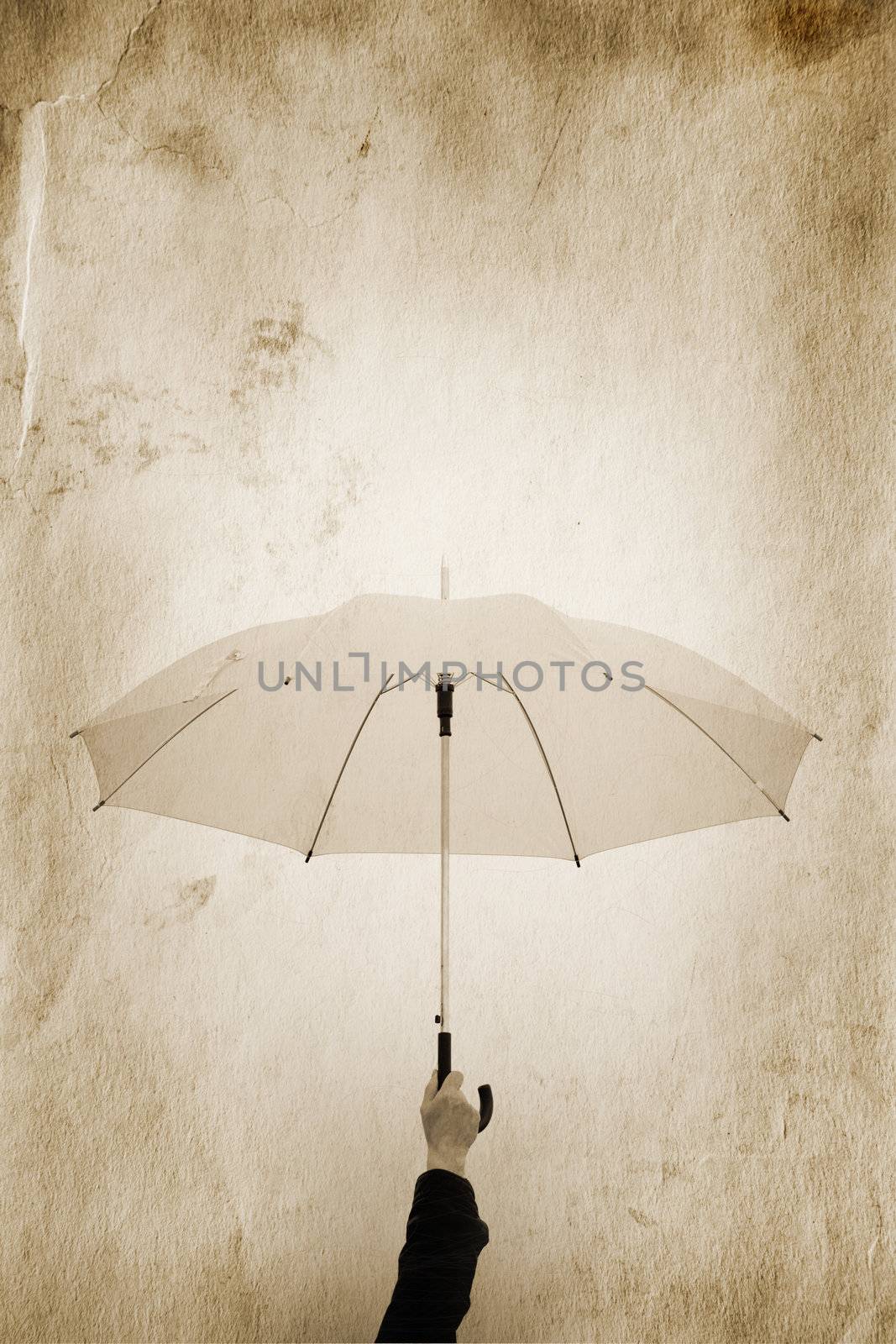 hand with umbrella and  grunge toned paper texture