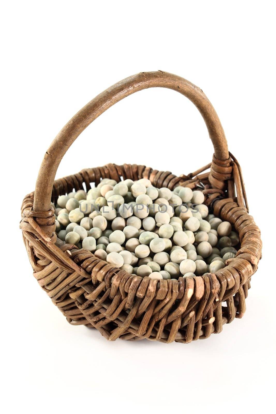 dried green peas in a basket on a white background