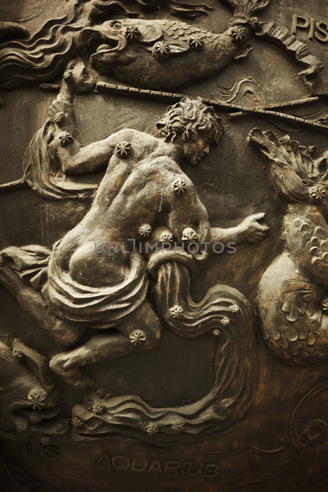 classic bronze bas-relief of man with water, astrology concept,selective focus