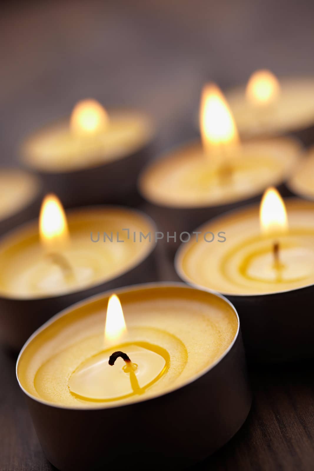 some tealight on wooden table, selective focus on nearest 