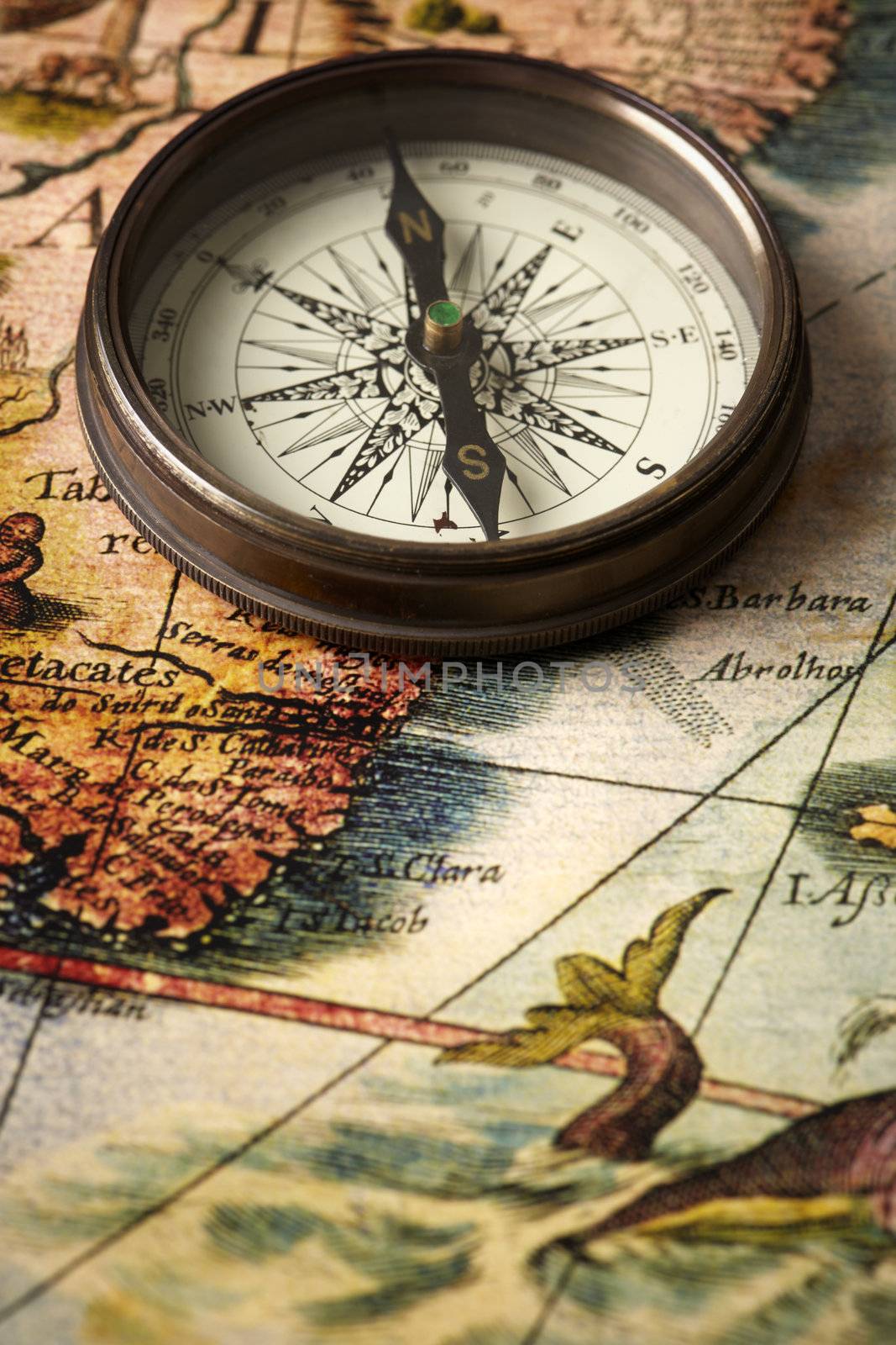 vintage compass on a map by Kuzma
