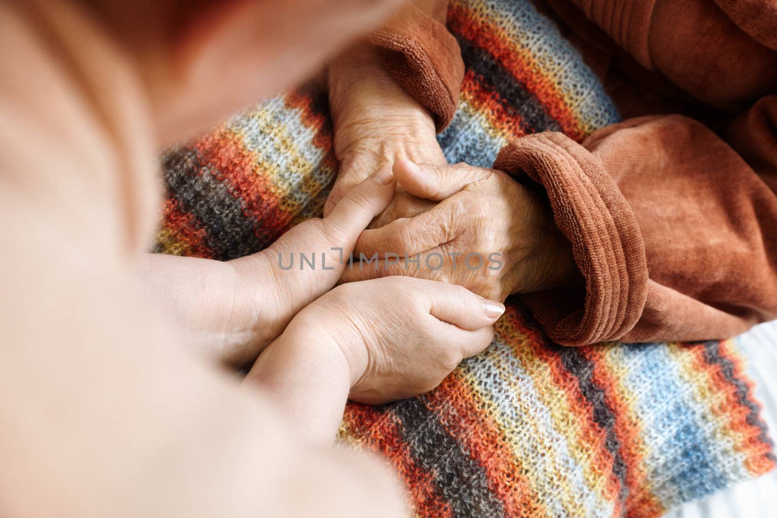 adult helps senior in hospital,selective focus