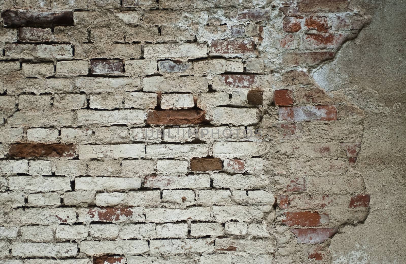 Old brick wall with pale gray and red bricks