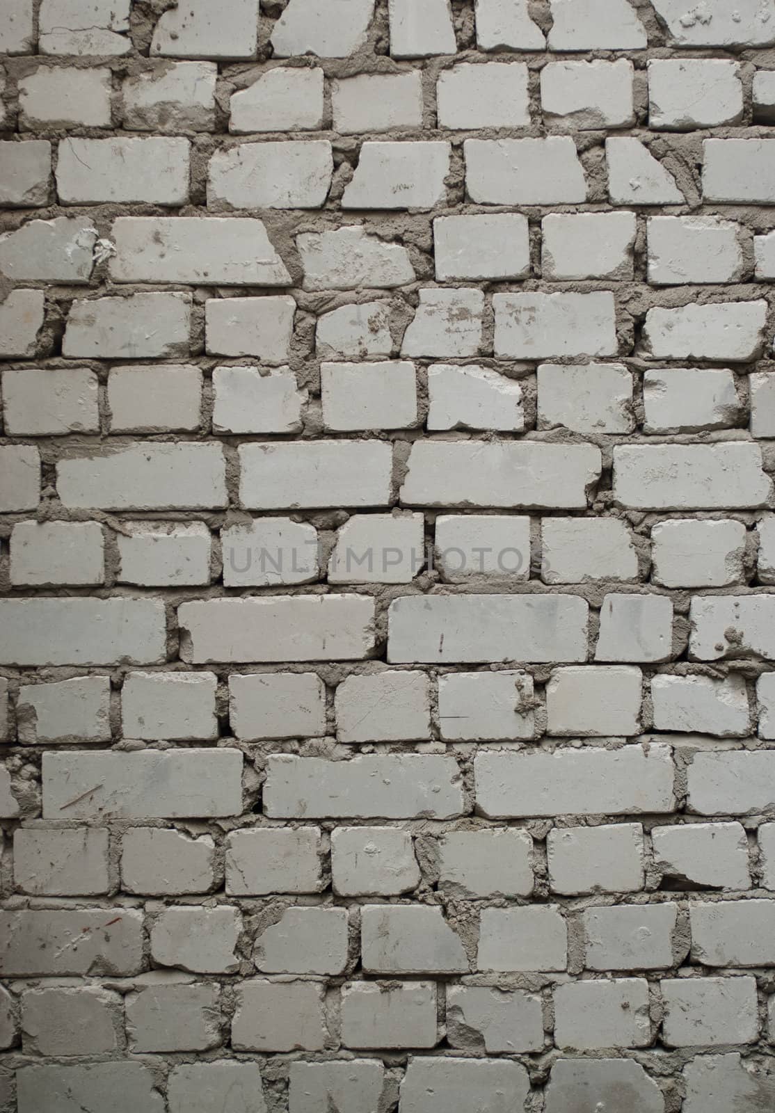 Old brick wall with pale gray bricks