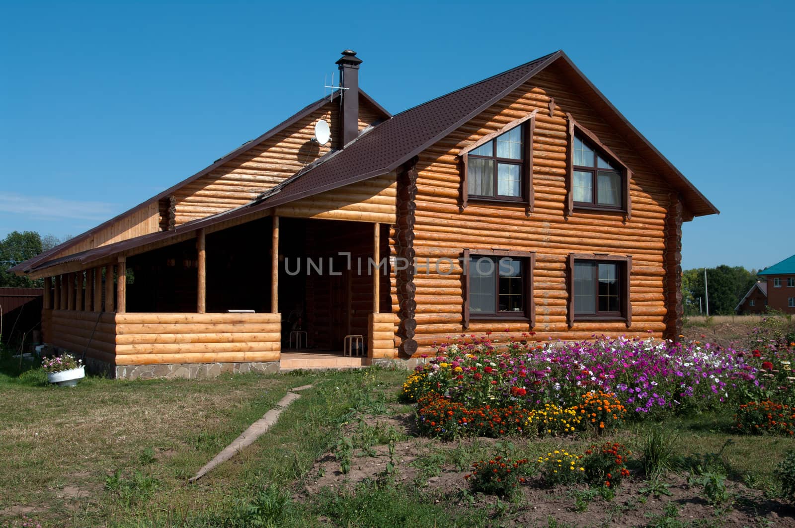 Country log house in the sunny summer day.
