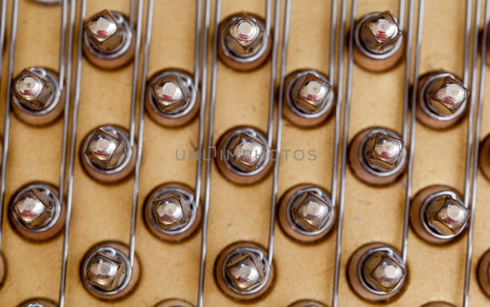Close up image of interior of grand piano showing strings and structure