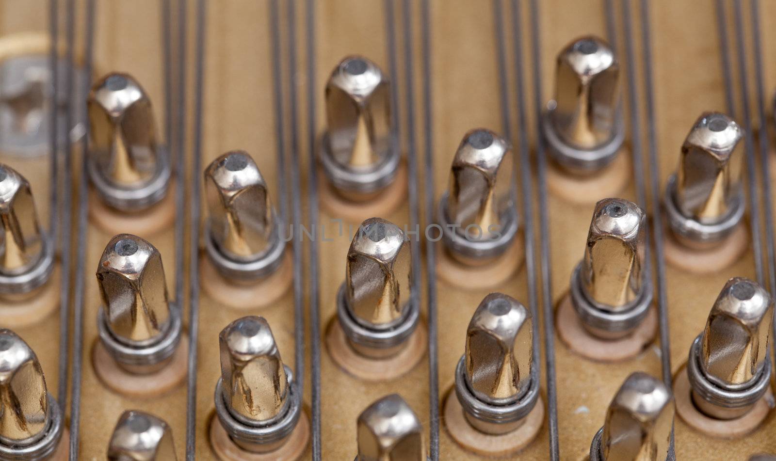 Close up image of interior of grand piano showing strings and structure