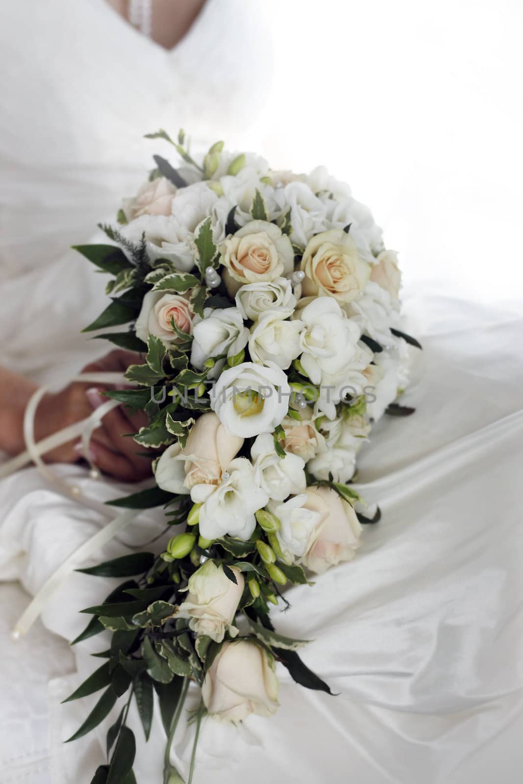 The bride holds a wedding bouquet