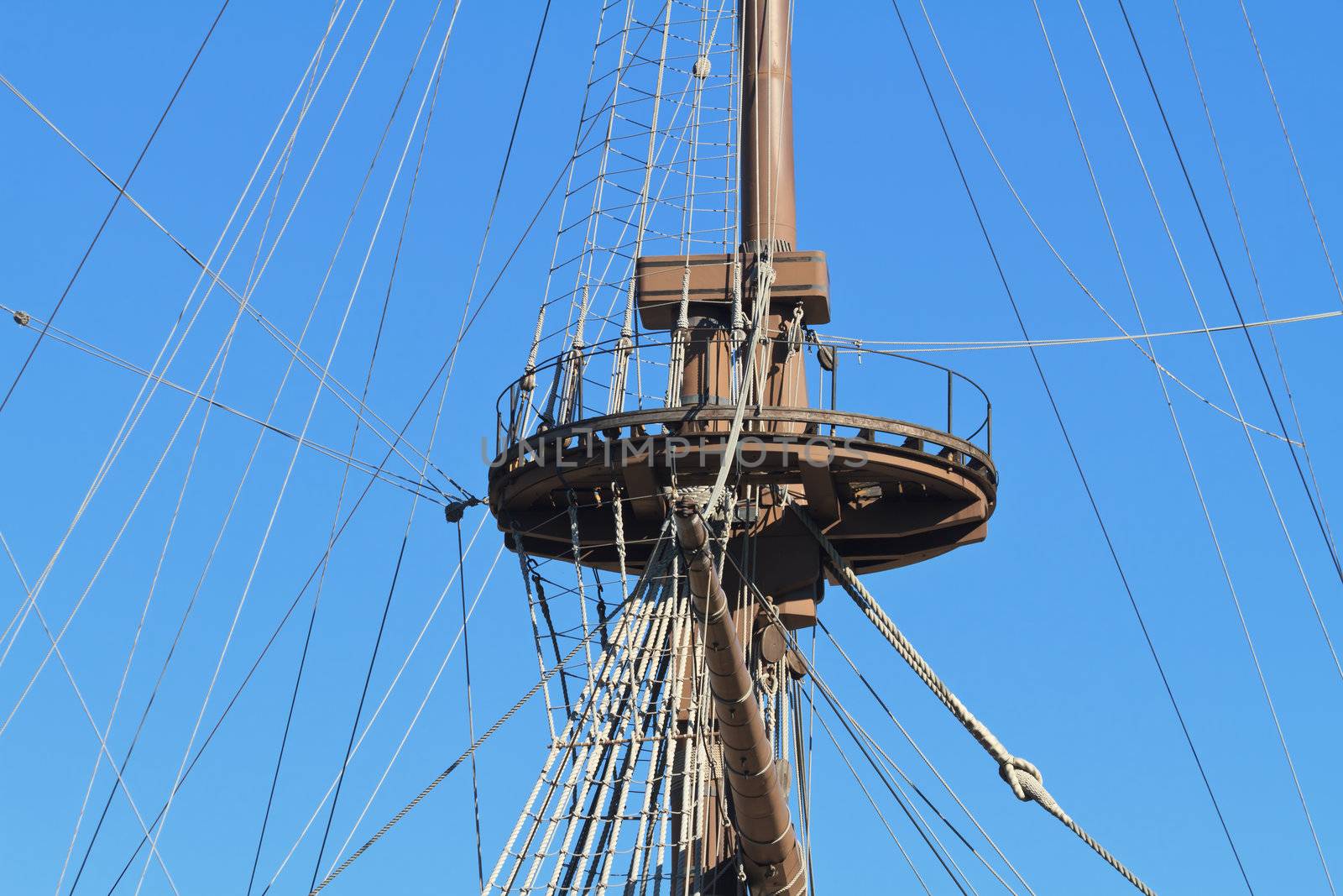 Detail of an ancient ship mast with bright blue sky