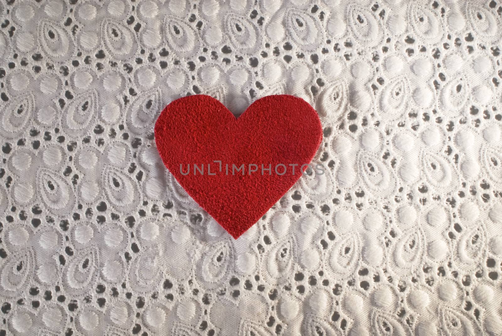 Retro Love. White fabric and red heart shape conceptual composition. Macro texture close up useful as background for design works.