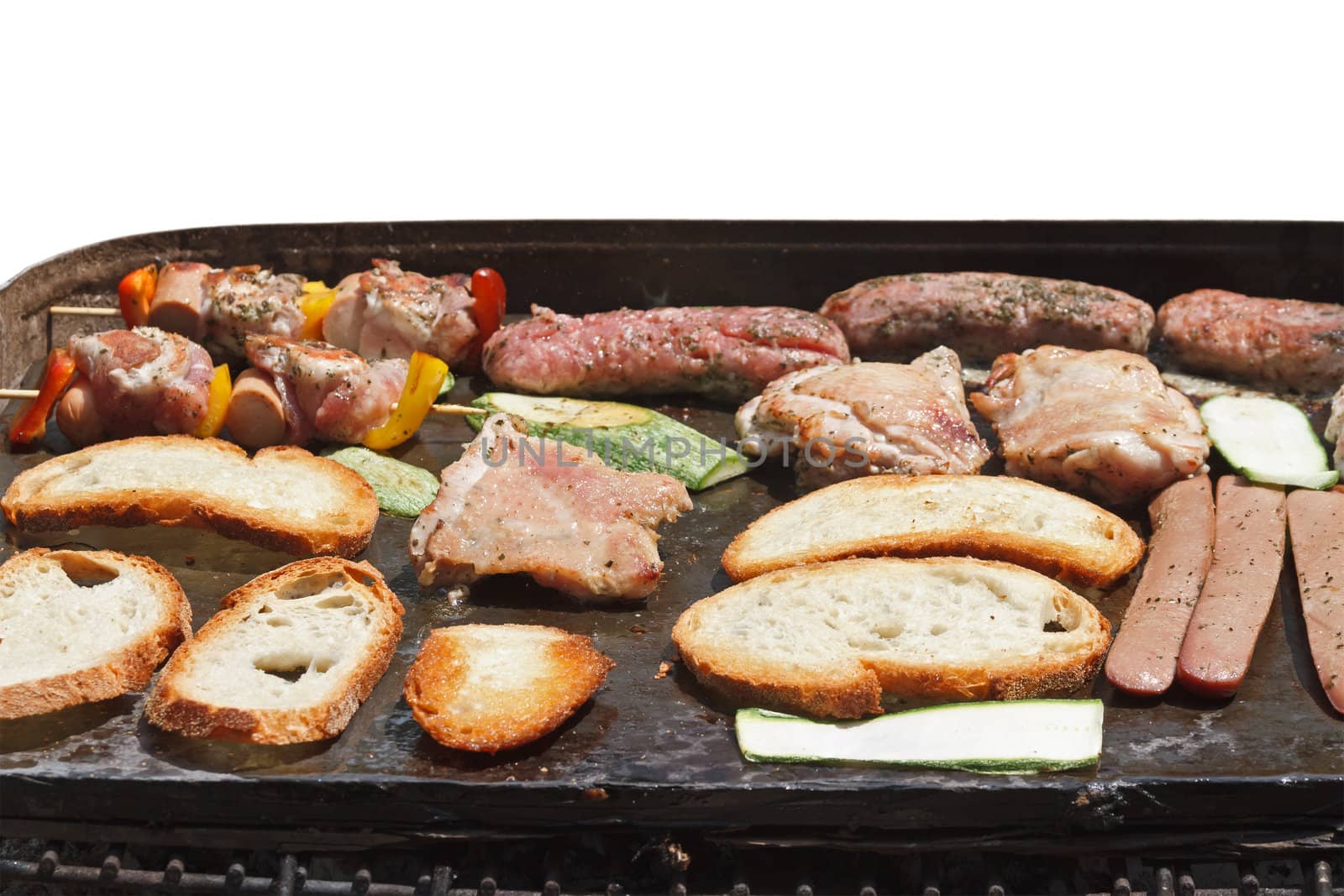 barbecue with meat, sausage, bread and vegetables isolated on white