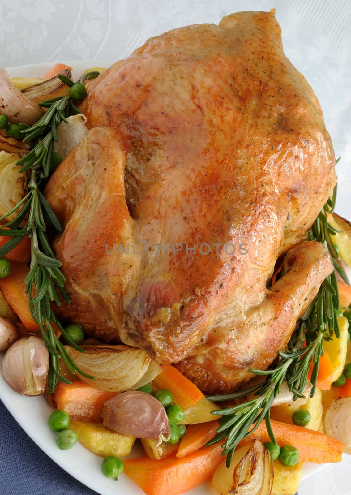 Baked chicken with vegetables and whole rosemary