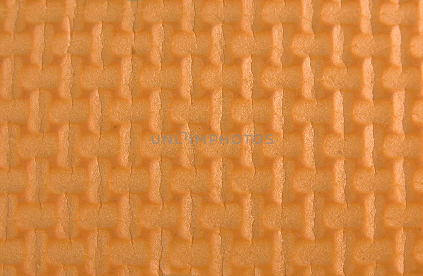 Orange woven rubber texture macro shot. Useful as background for design.