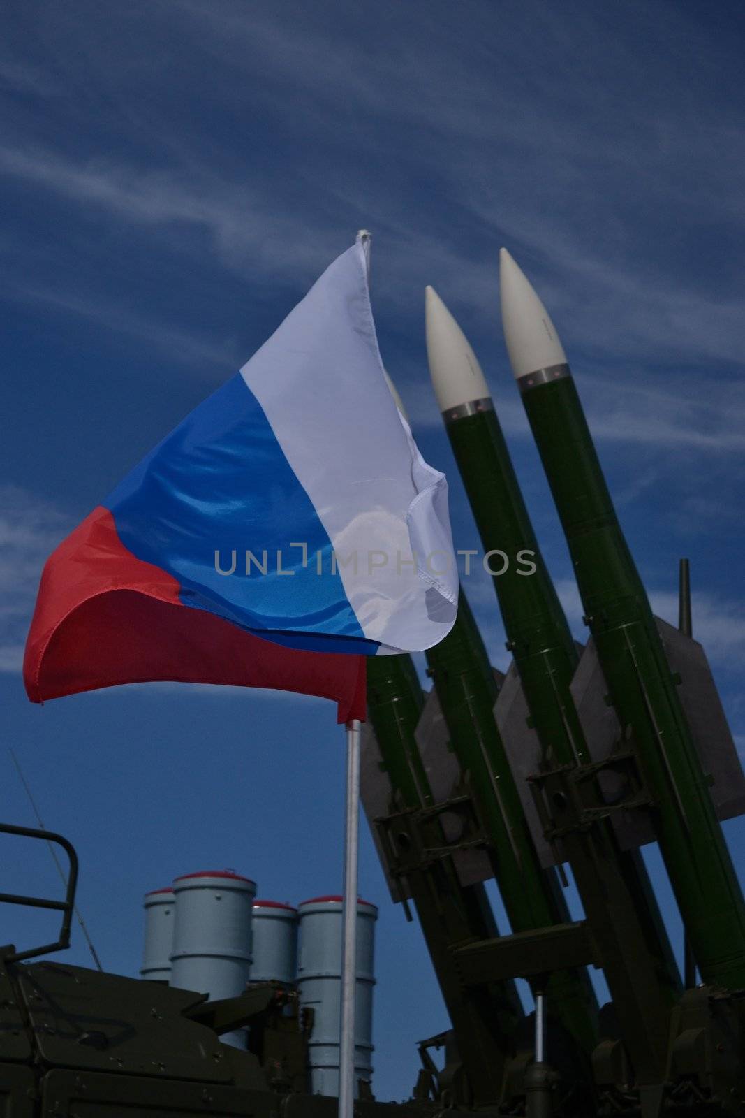 Waving Russian flag over the rockets and the blue sky