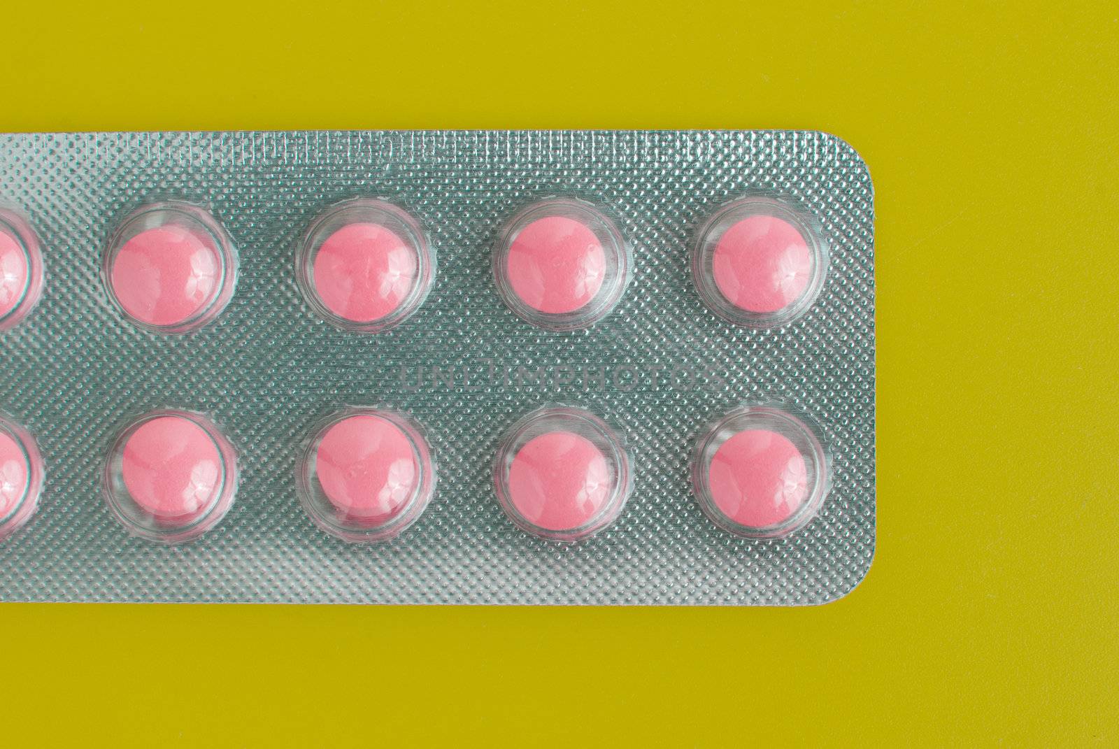 Macro view of medical pills on green background.