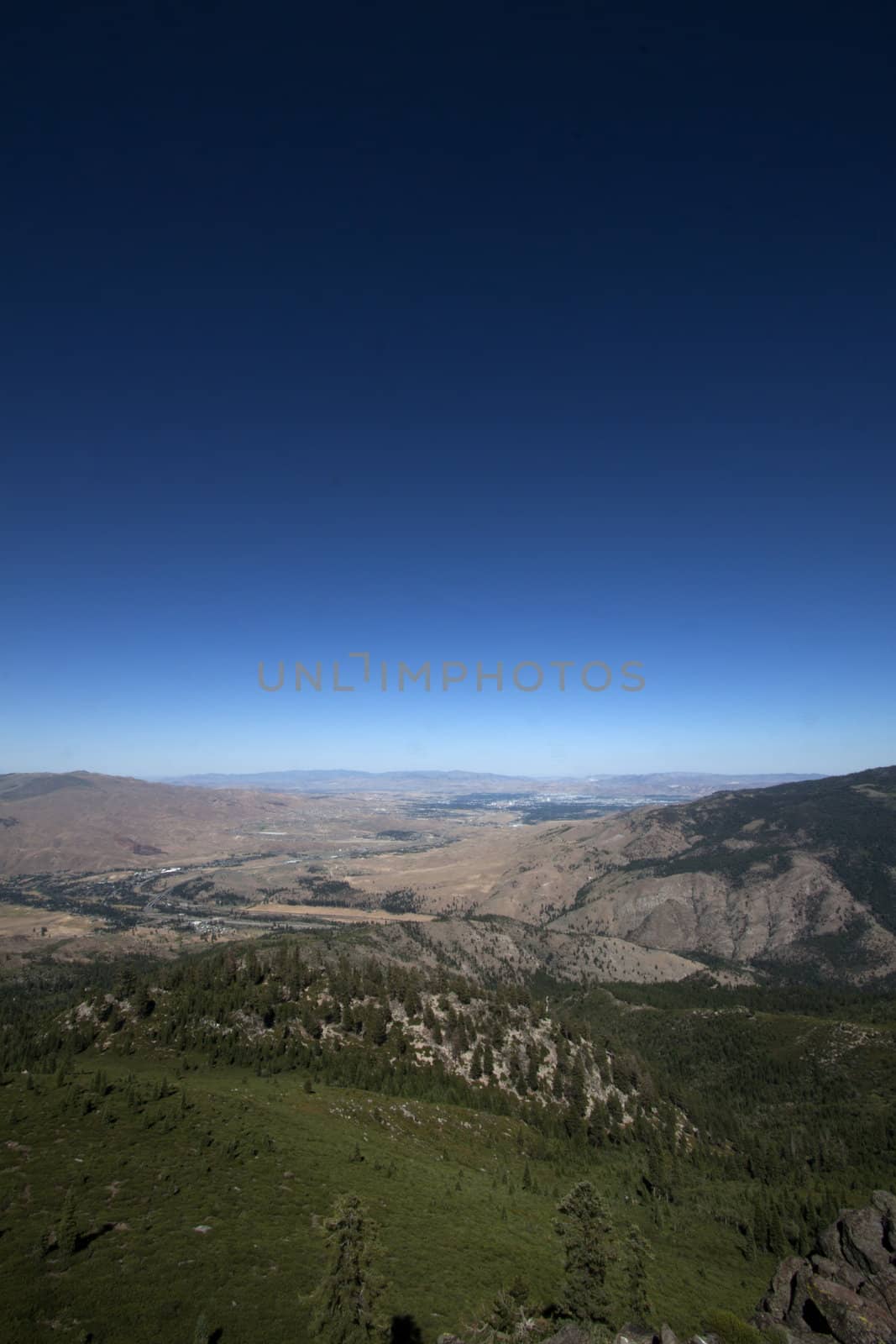 HIgh shot of a mountain range with a blue sky by jeremywhat