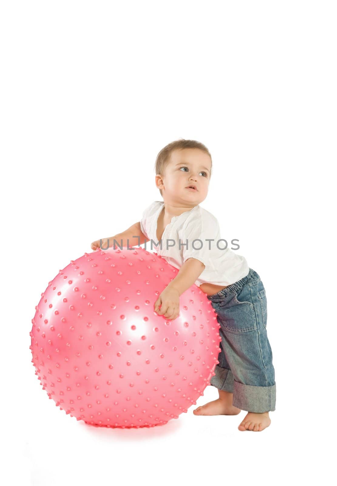 A little boy with a big pink fitness ball