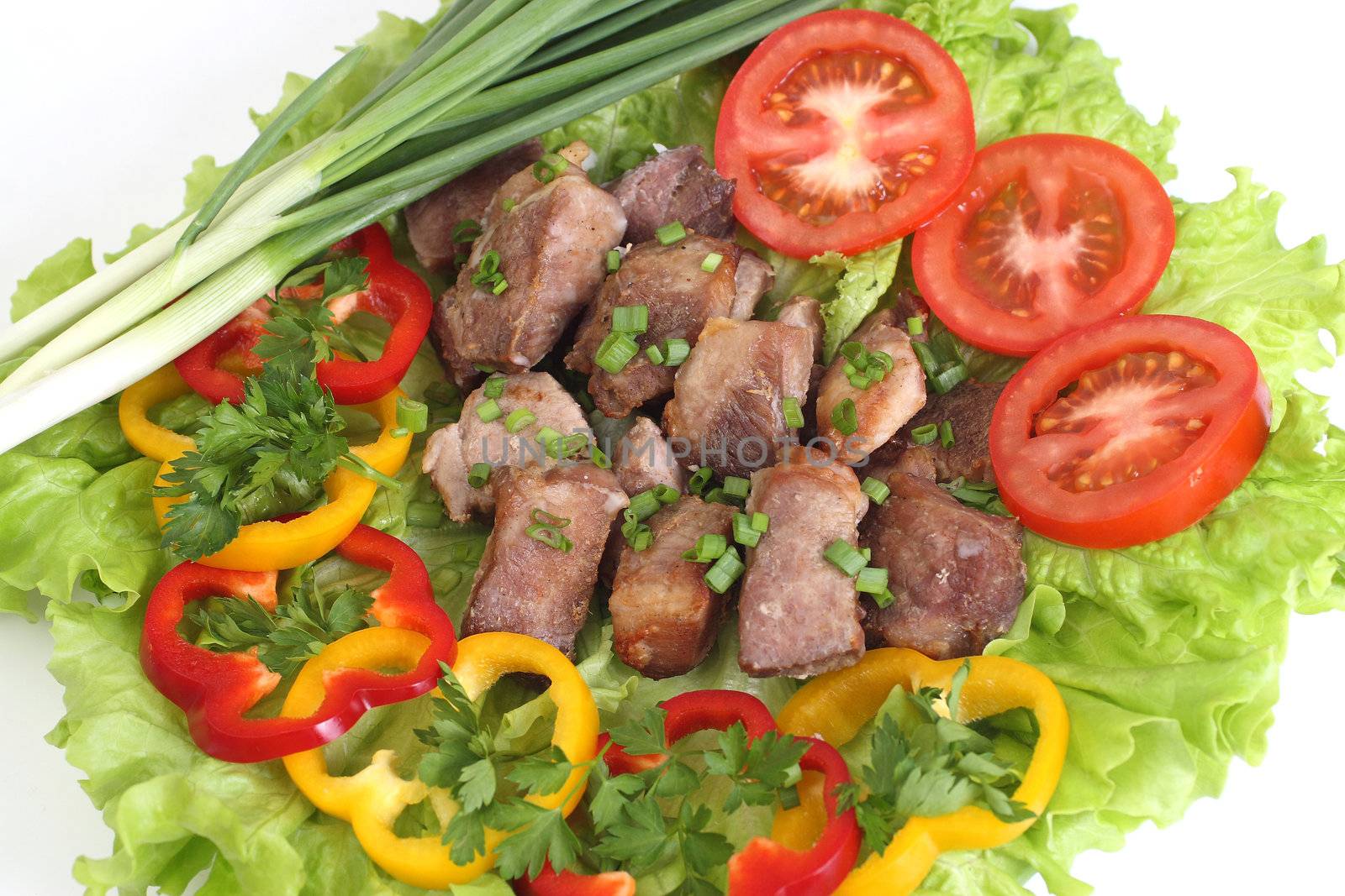 Appetizing shish kebab with tomatoes and greens