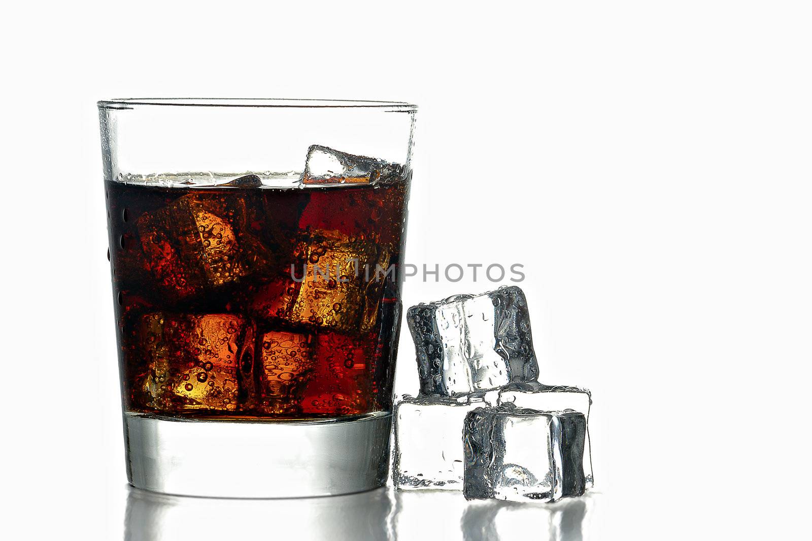 Fresh Cold Cola with ice in glass and next to glass isolated on white background