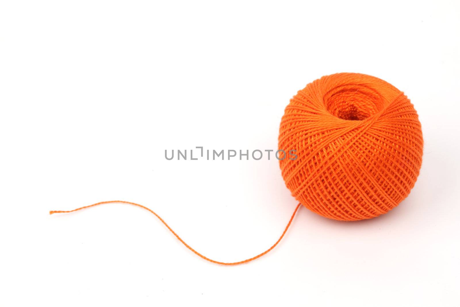thread on blue silk background close up
