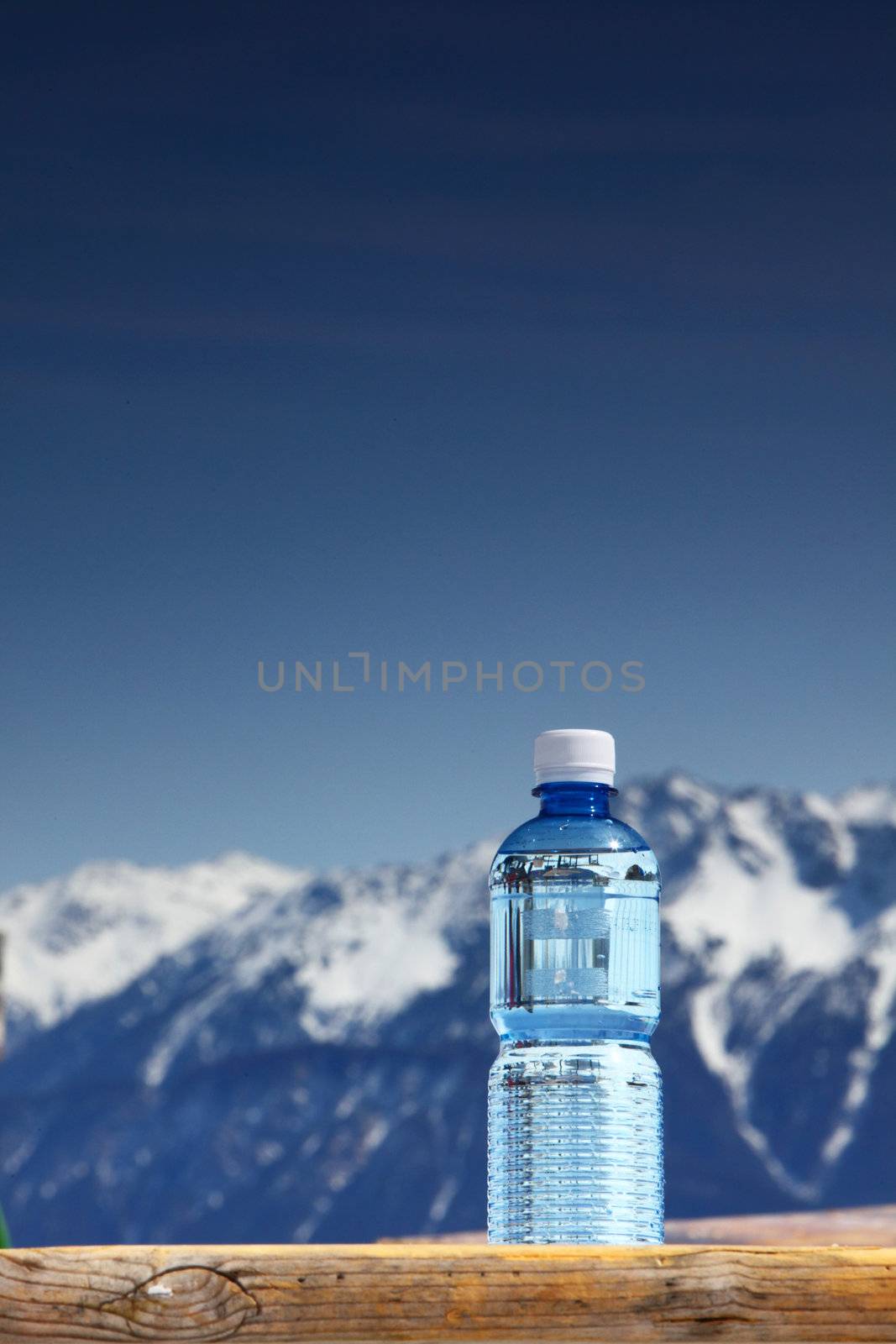 water in cup mountains on background