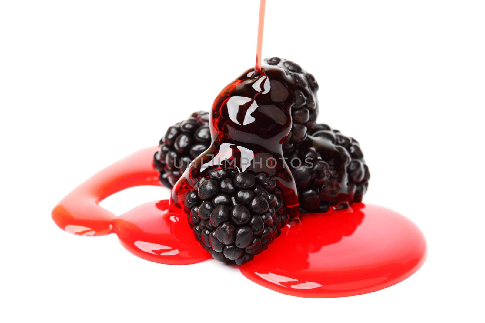 blackberry pile in syrup isolated on white