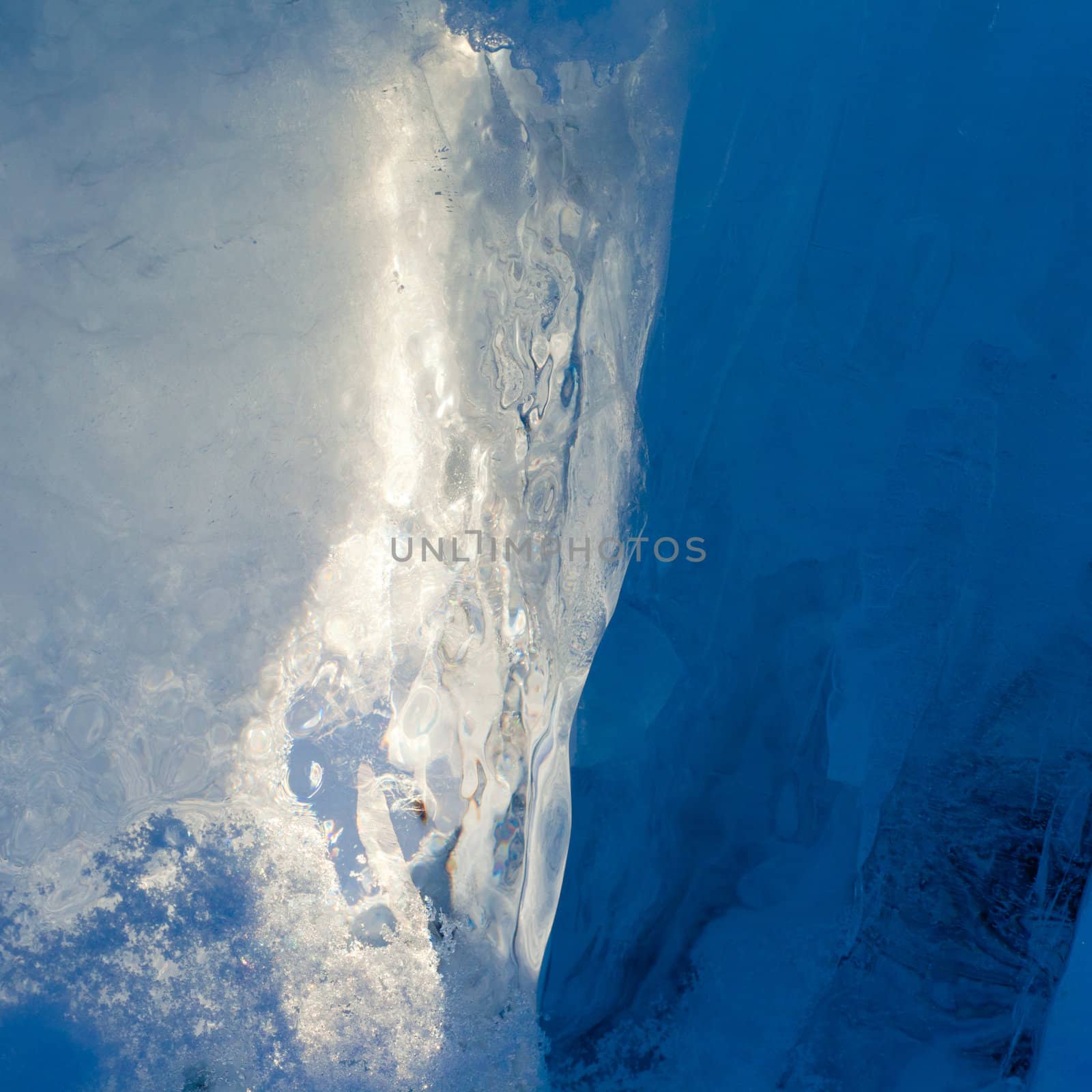 Ice forming a cave-like structure beautifully illuminated by sunlight.