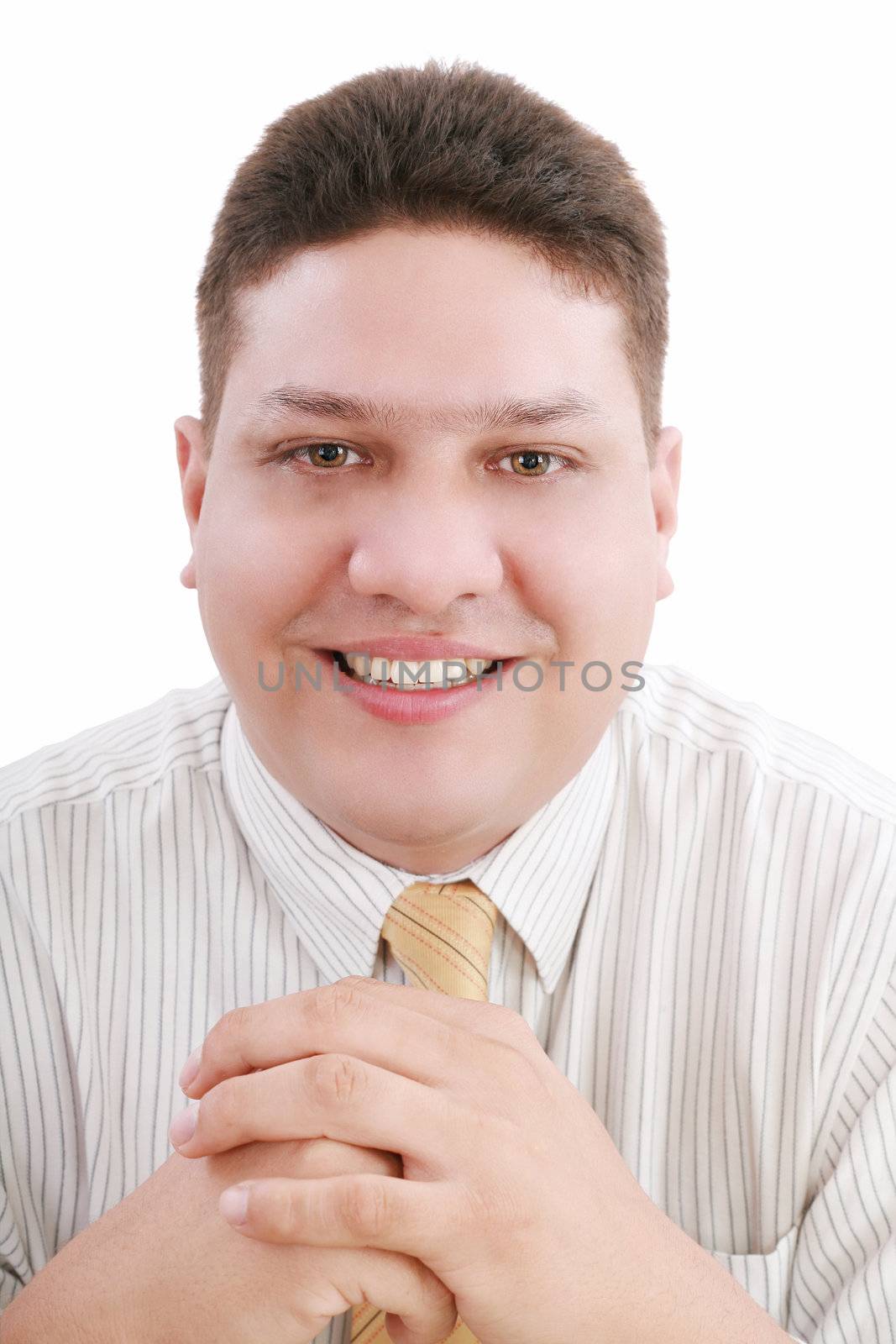 Caucasian man with hands folded in front smiling at viewer.