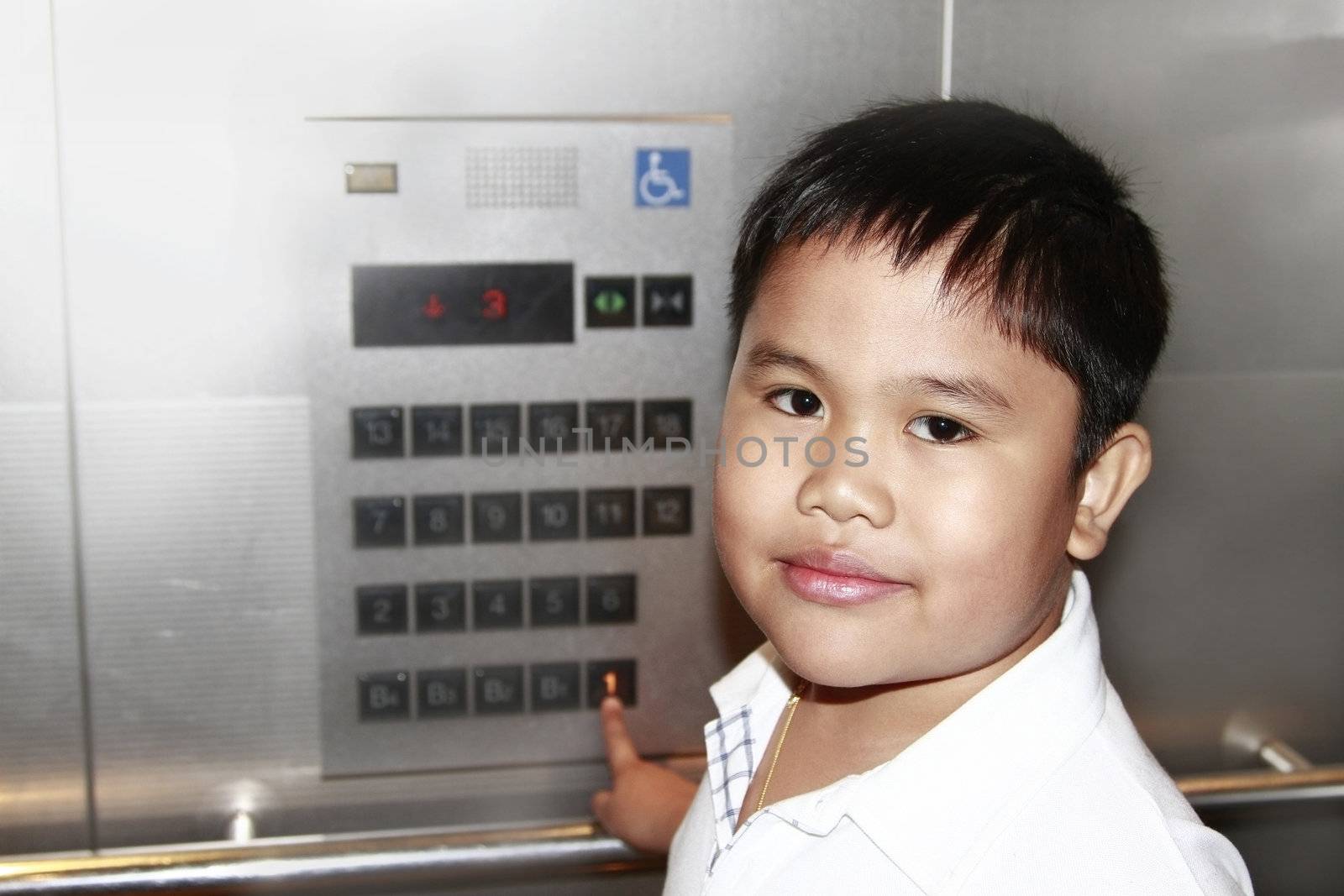 Portrait of asian boy inside an elevator.