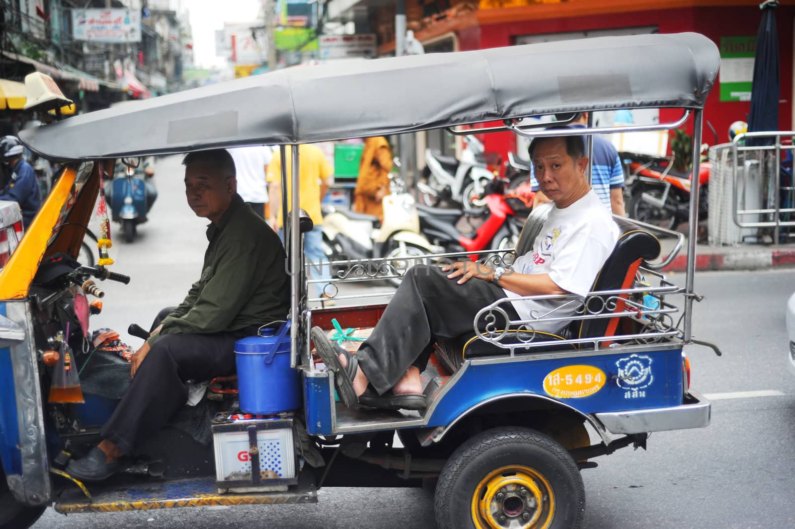 Bangkok, Thailand  -  March 26, 2011: Bangkok Tuk-tuk with passengers in traffic jam