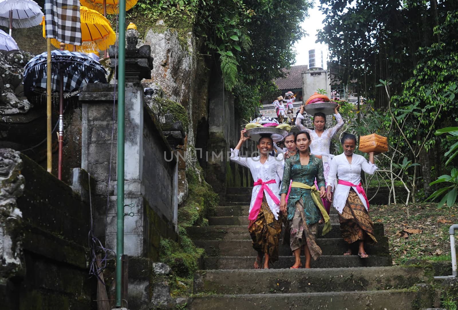 Ubud, Bali island, Indonesia - April, 06, 2011: Unidentified local woman wearing in traditional indonesian clothes take part in Buda Wage Kelawu ceremony at Hindu temple.