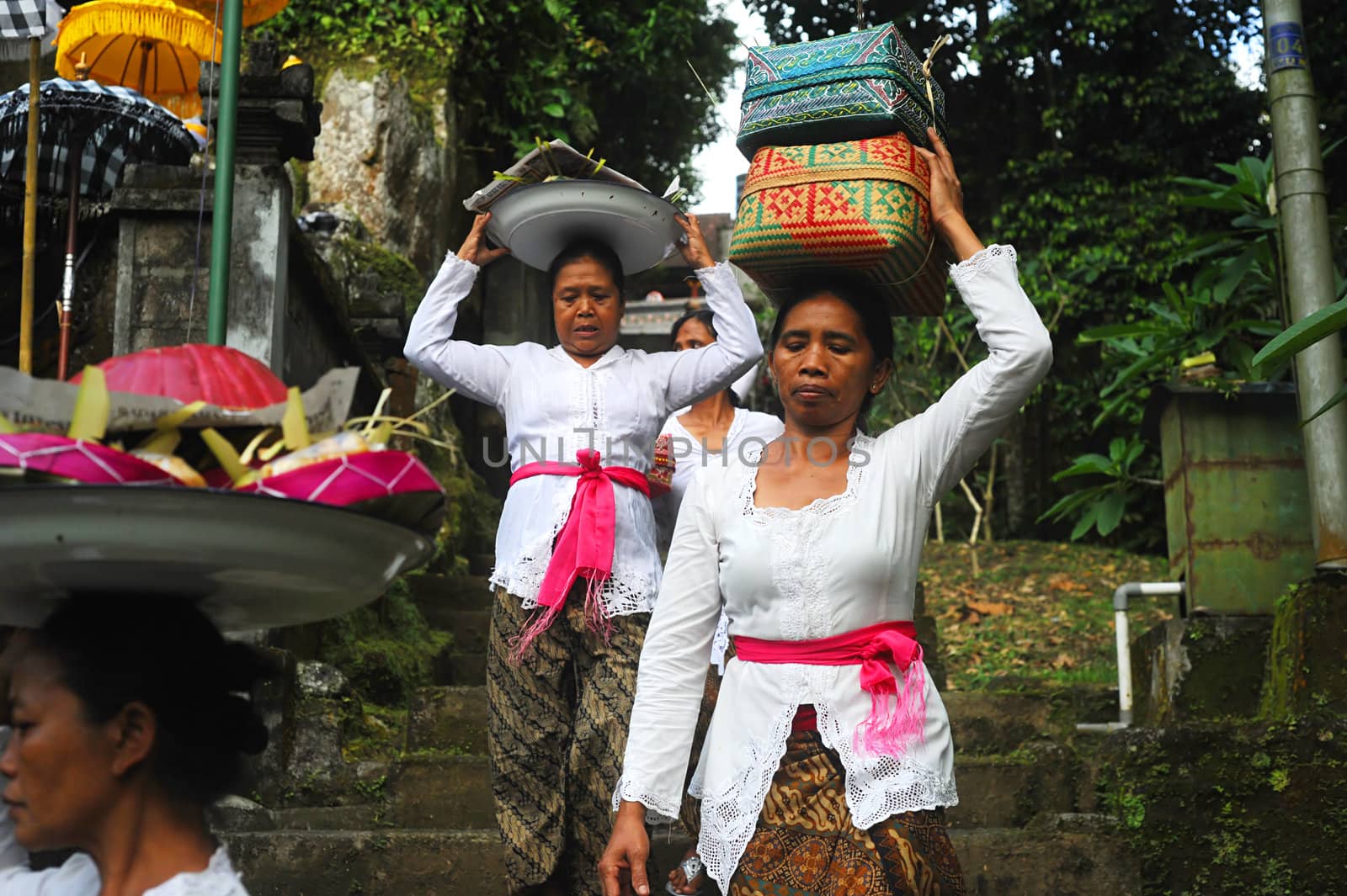 Ubud, Bali island, Indonesia - April, 06, 2011: Unidentified local woman wearing in traditional indonesian clothes take part in Buda Wage Kelawu ceremony at Hindu temple.