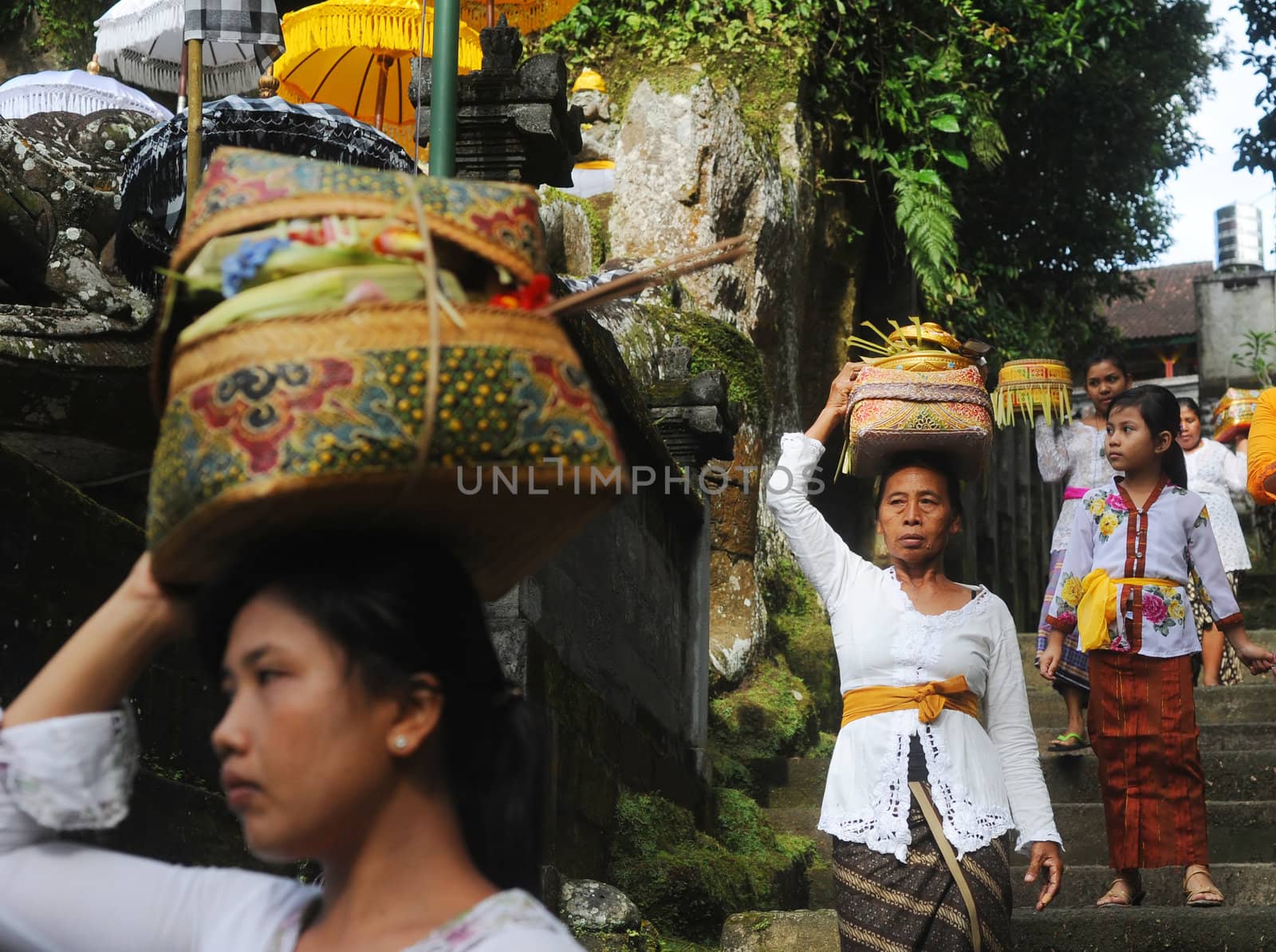 Ubud, Bali island, Indonesia - April, 06, 2011: Unidentified local woman wearing in traditional indonesian clothes take part in Buda Wage Kelawu ceremony at Hindu temple.