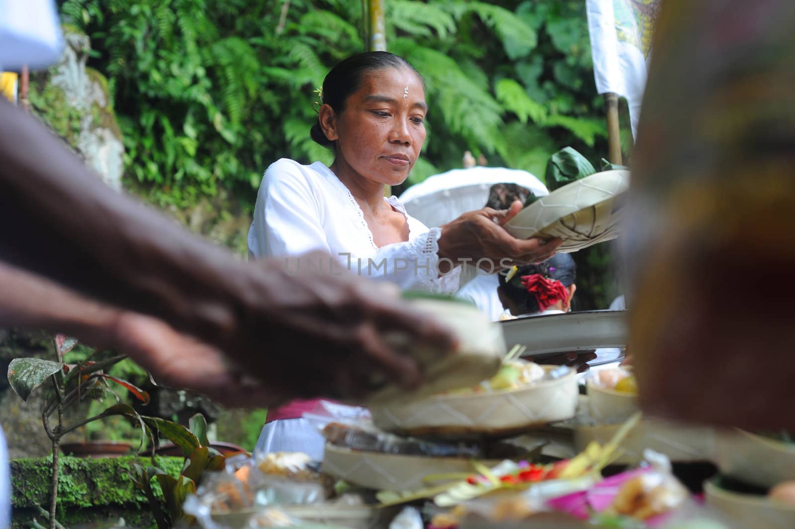 Ubud, Bali island, Indonesia - April, 06, 2011: Unidentified local woman wearing in traditional indonesian clothes take part in Buda Wage Kelawu ceremony at Hindu temple.