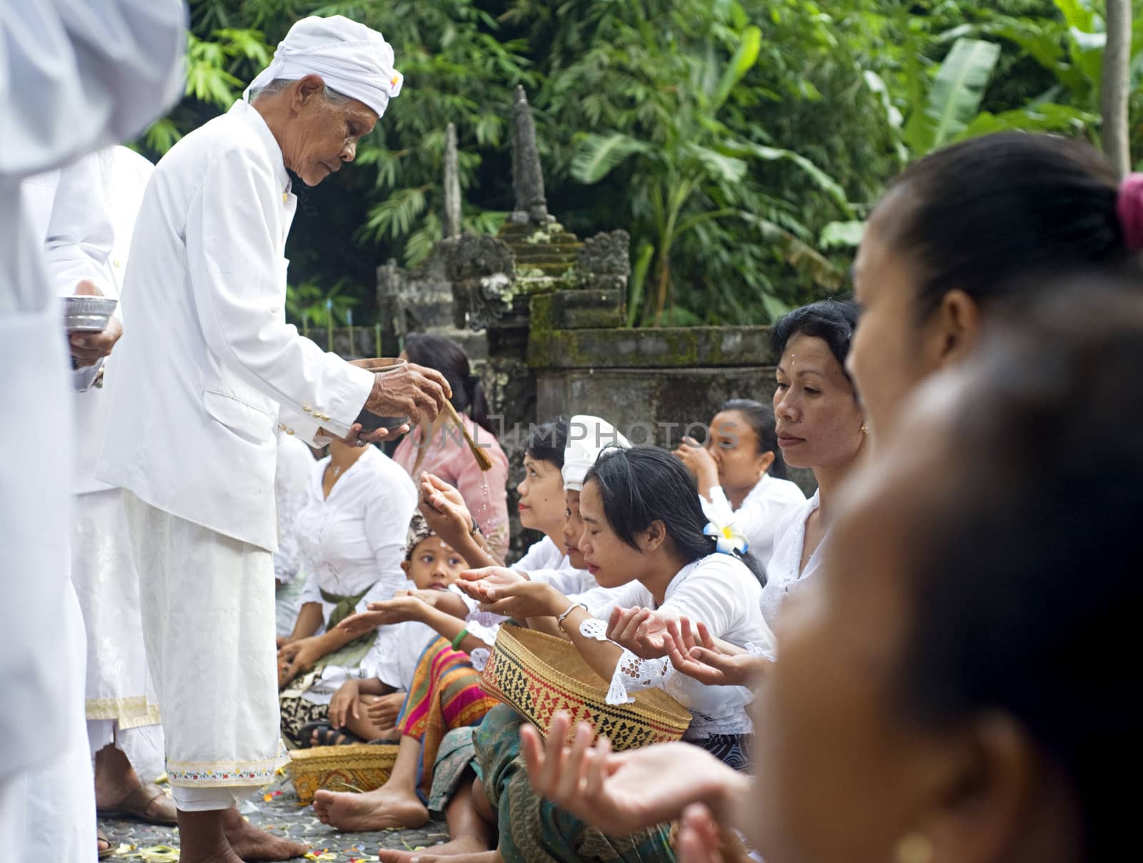 Ubud, Bali island, Indonesia - April, 06, 2011: Unidentified local people wearing in traditional indonesian clothes take part in Buda Wage Kelawu ceremony at Hindu temple.