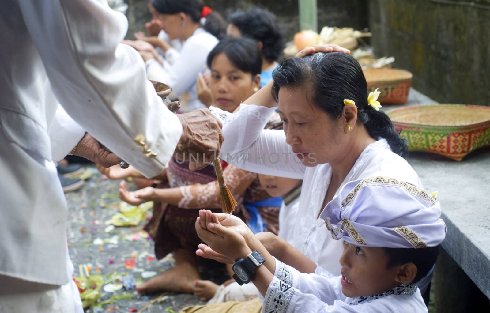 Ubud, Bali island, Indonesia - April, 06, 2011: Unidentified local boy wearing in traditional indonesian clothes take part in Buda Wage Kelawu ceremony at Hindu temple.