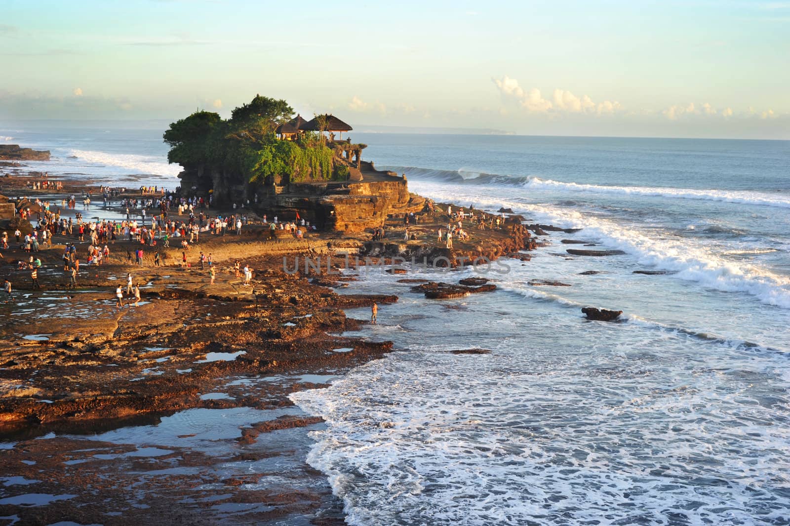 Tanah Lot is a rock formation off the Indonesian island of Bali. It is home of a pilgrimage temple, the Pura Tanah Lot (literally "Tanah Lot temple") and a popular tourist and cultural icon for photography and general exoticism