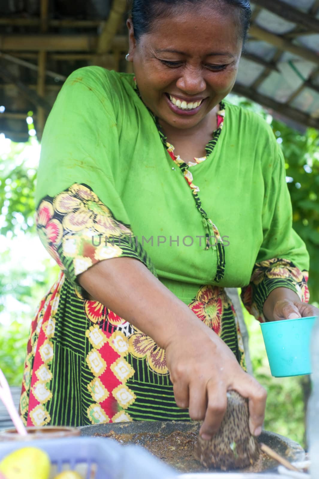 Java,Indonesia-April 21,2011:A smiling woman selling fast food near  the road 