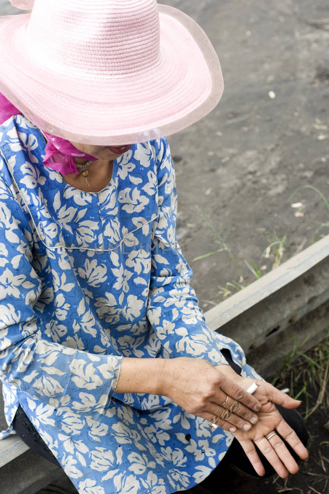 Probolingo, Indonesia - April 24,2011: Unidentified indonesian woman rolling  cigarette. Smoking in Indonesia is a common practice, as over 165 million people smoke in Indonesia. Of Indonesian people, 63% of men and 5% of women reported as smokers, a total of 34% of the population.