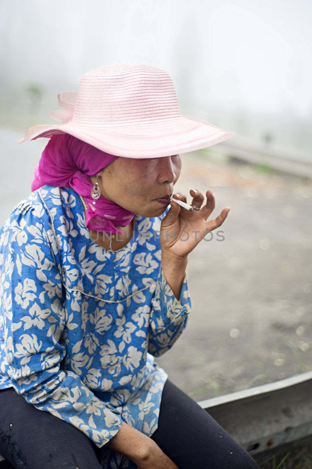 Probolingo, Indonesia - April 24,2011: Unidentified indonesian woman smoking  cigarette. Smoking in Indonesia is a common practice, as over 165 million people smoke in Indonesia. Of Indonesian people, 63% of men and 5% of women reported as smokers, a total of 34% of the population.