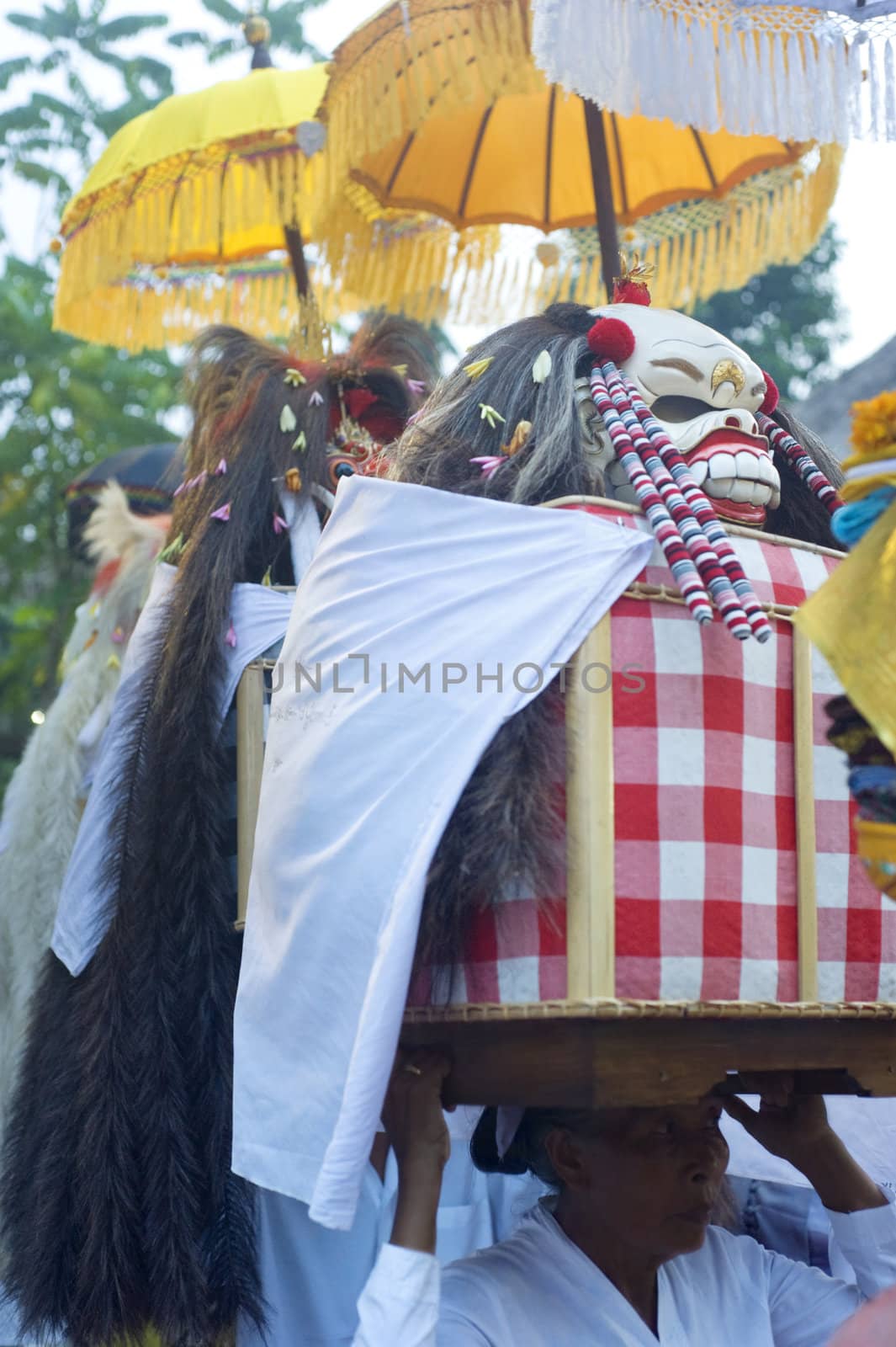Ubud, Bali island, Indonesia - April, 30, 2011: Unidentified local people wearing in traditional indonesian clothes take part in Wayang Ceng Blonk ceremony at Hindu temple.