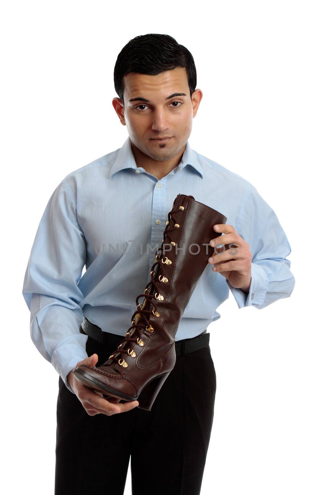 A shoe salesman holding a brown leather lace up boot.  White background.
