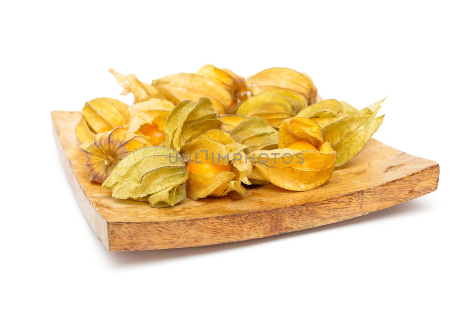 Physalis fruits on a wooden dish on white background