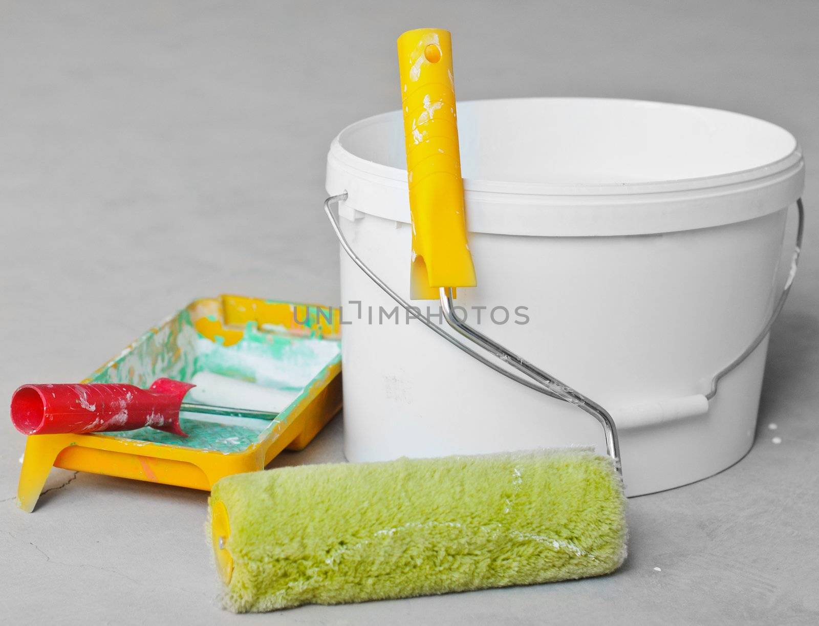 Home Improvement Paint Roller And Paint Tin near wall