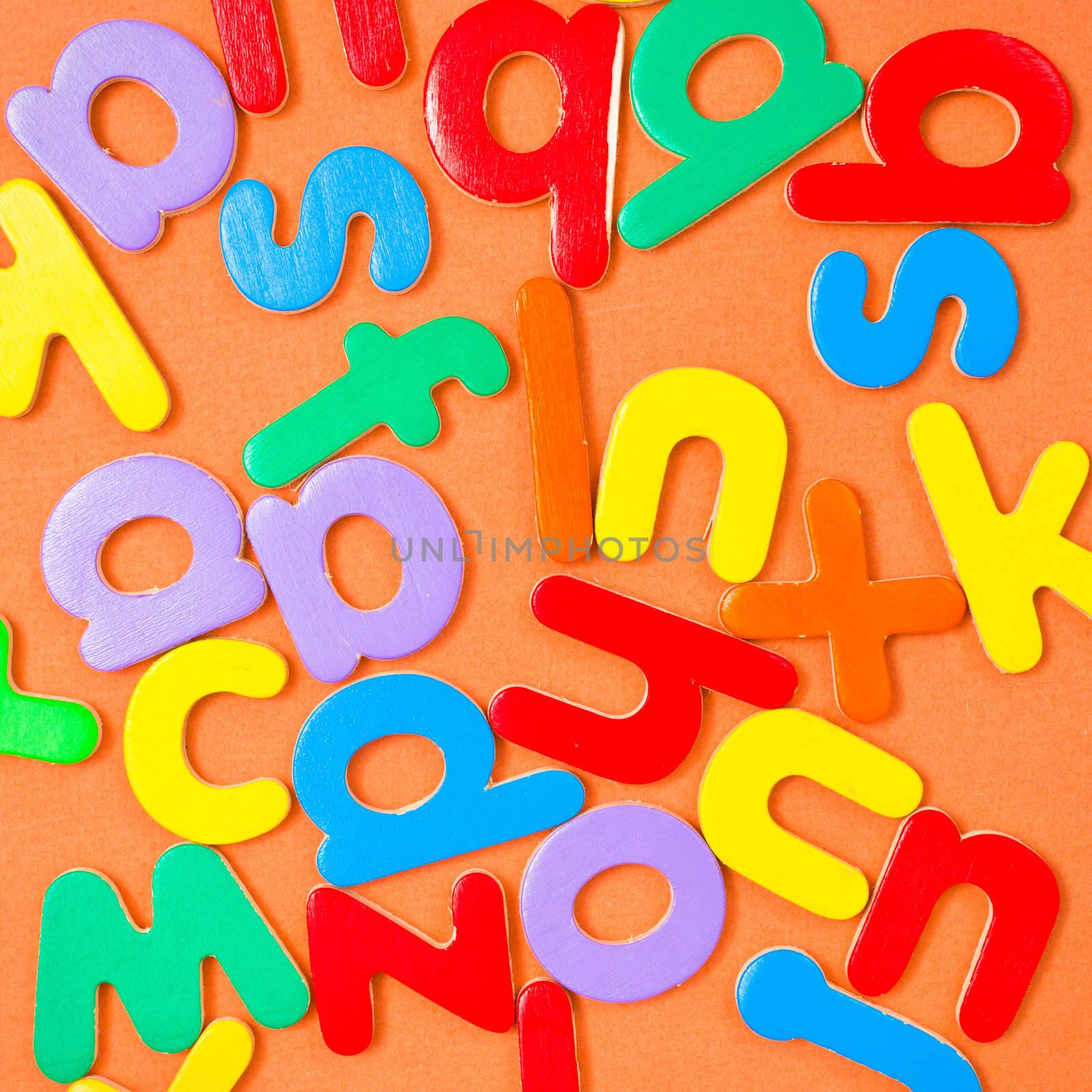 Square background composed of colorful letters of the alphabet
