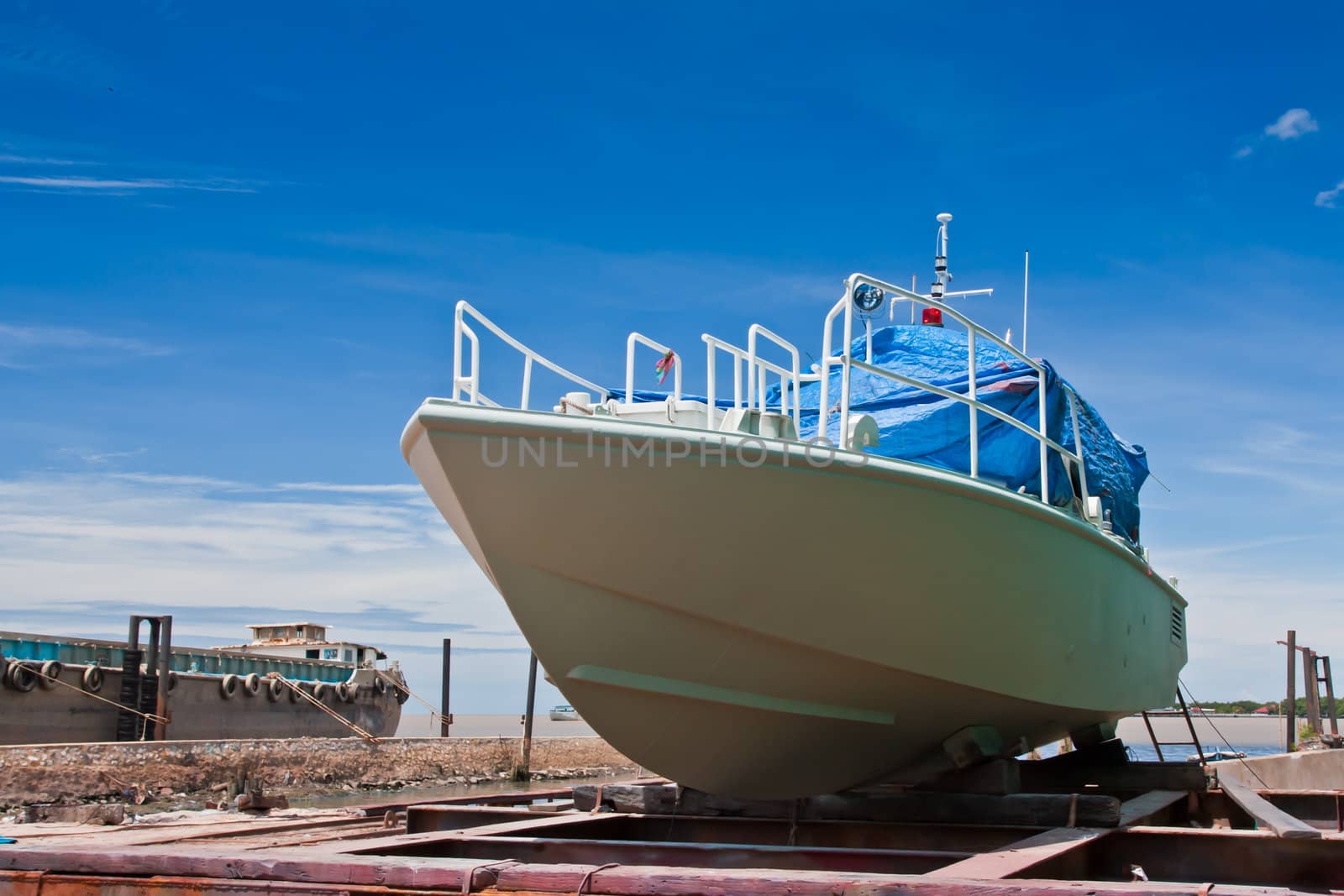 Boat painting at dry dock and blue sky